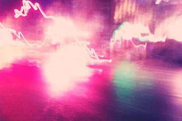 Rainy night street streaks.