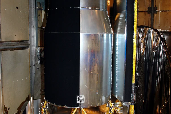 KENNEDY SPACE CENTER, FLA.  - In the mobile service tower on Launch Pad 17-B, Cape Canaveral Air Force Station, the Space Infrared Telescope Facility (SIRTF) waits for encapsulation. SIRTF will obtain images and spectra by detecting the infrared energy, or heat, radiated by objects in space. Consisting of a 0.85-meter telescope and three cryogenically cooled science instruments, SIRTF will be the largest infrared telescope ever launched into space. It is the fourth and final element in NASA’s family of orbiting “Great Observatories.” Its highly sensitive instruments will give a unique view of the Universe and peer into regions of space that are hidden from optical telescopes.
