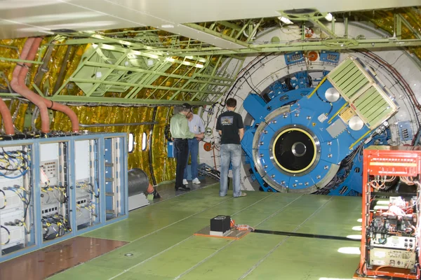 Technicians check out the mounting structure of the infrared telescope installed in NASA's Stratospheric Observatory for Infrared Astronomy (SOFIA)