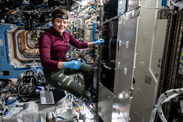 NASA astronaut Anne McClain swaps filters inside the Kermit microscope