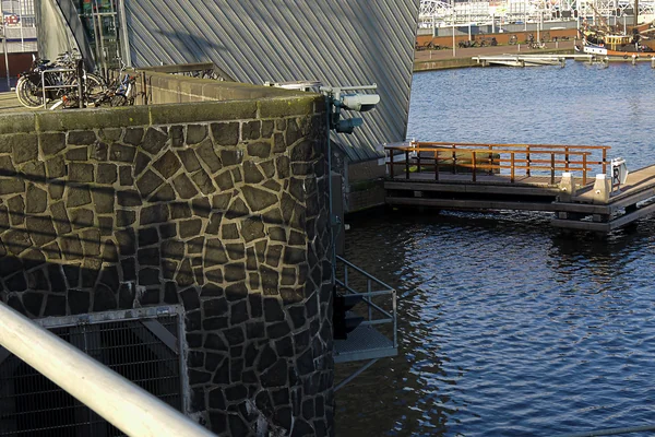 View on the Oosterdok waterfront in Amsterdam city with the small modern architecture museum Arcam and the Science Center Nemo, built upon the IJ-tunnel; location Prins Hendrikkade - urban photography by Fons Heijnsbroek, the Netherlands, 2013