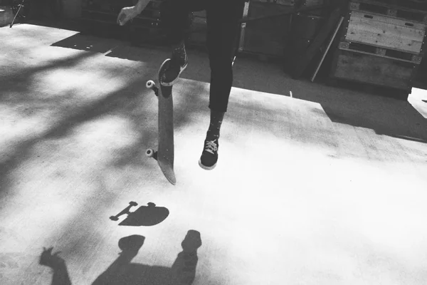 Grayscale person doing skateboarding tricks