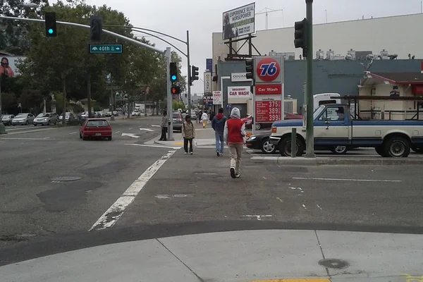 Pedestrians cross 40th Street at Broadway against the new green/don't walk signal phase