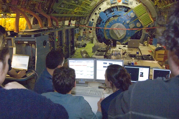 Scientists carefully examine data being received during nighttime line operations testing of the SOFIA airborne observatory's 2.5-meter infrared telescope