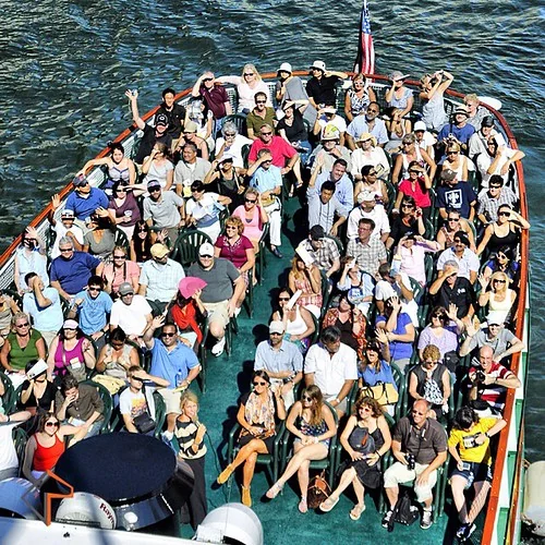 While crossing a bridge in Chicago with some friends I saw this tour boat approaching and, without thinking twice, leaned over the edge and yelled 'Everybody Wave!!!' and took this image. All of my friends laughed hysterically at my bold and socially awkw