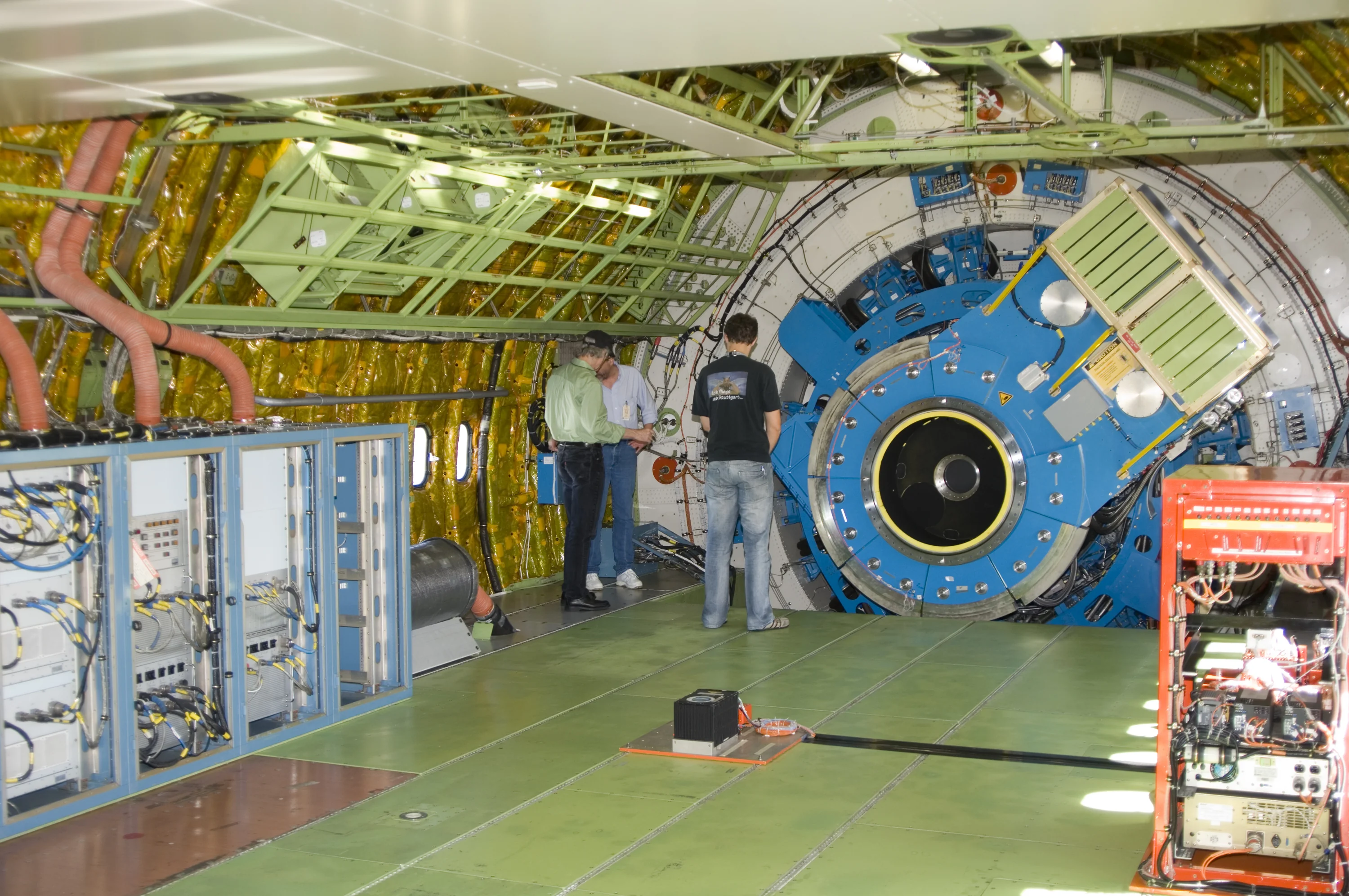 Technicians check out the mounting structure of the infrared telescope installed in NASA's Stratospheric Observatory for Infrared Astronomy (SOFIA)