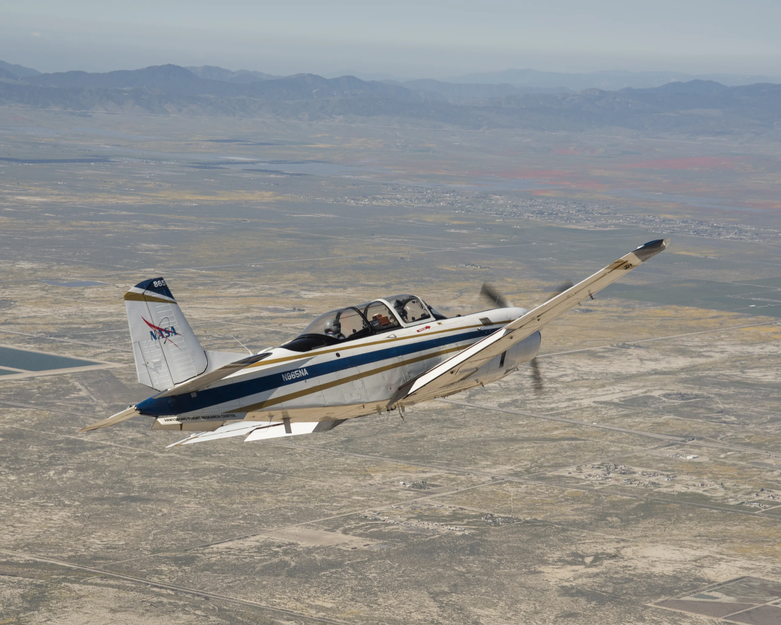 NASA Aircraft heads to Southern California's Poppy Reserve in the foreground. Rainy Season made the Antelope Valley colorful with poppies and wildflowers.