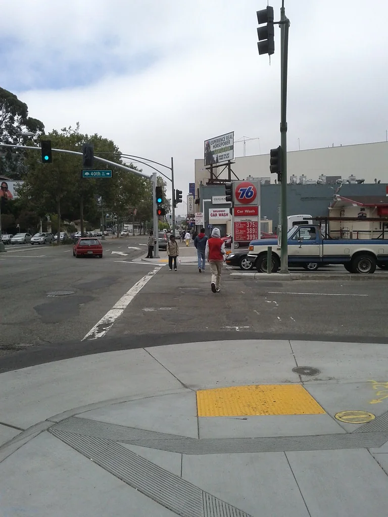 Pedestrians cross 40th Street at Broadway against the new green/don't walk signal phase