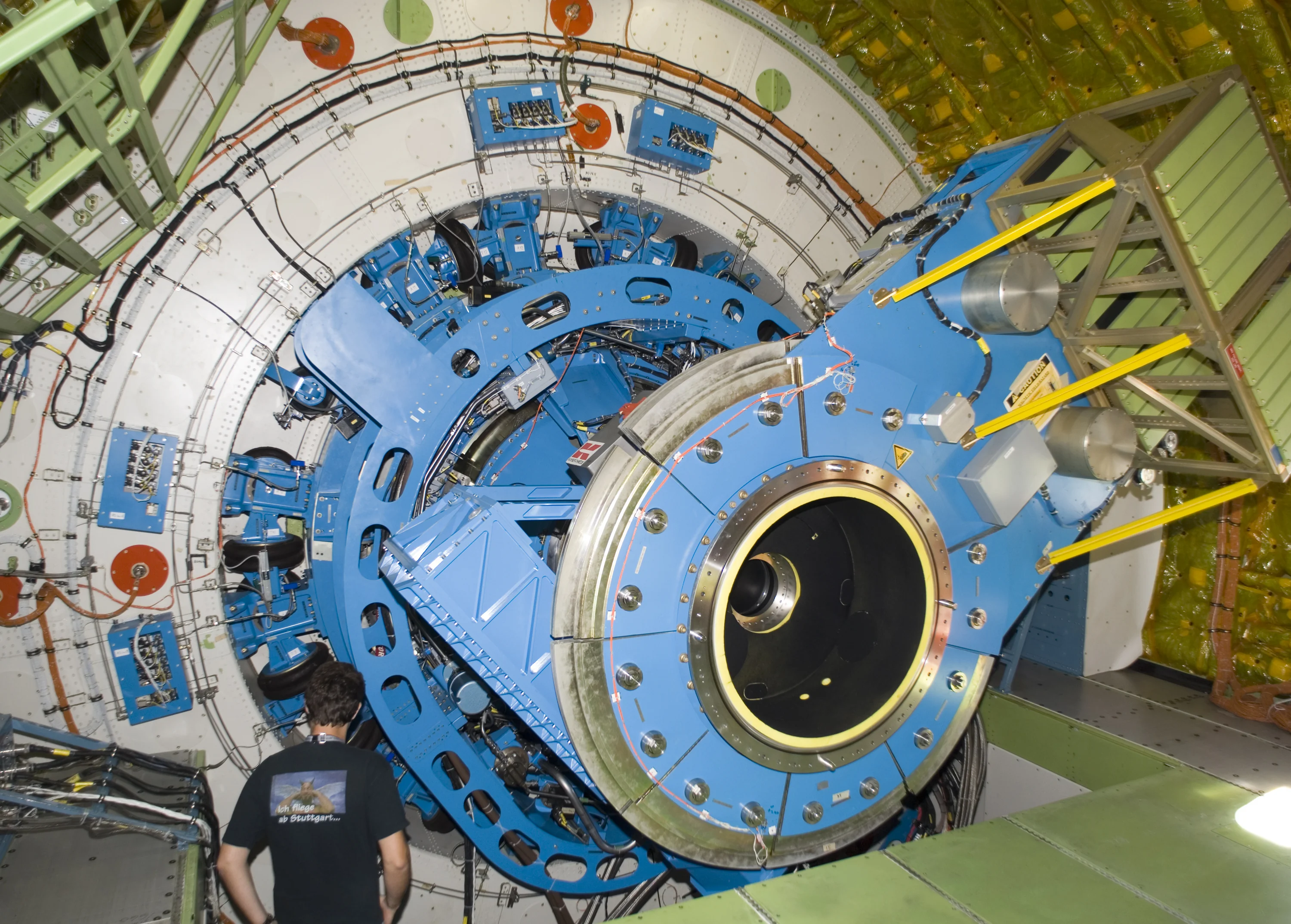 A technician examines the instrument mounting structure and bulkhead of the German-built infrared telescope installed in NASA's SOFIA airborne observatory